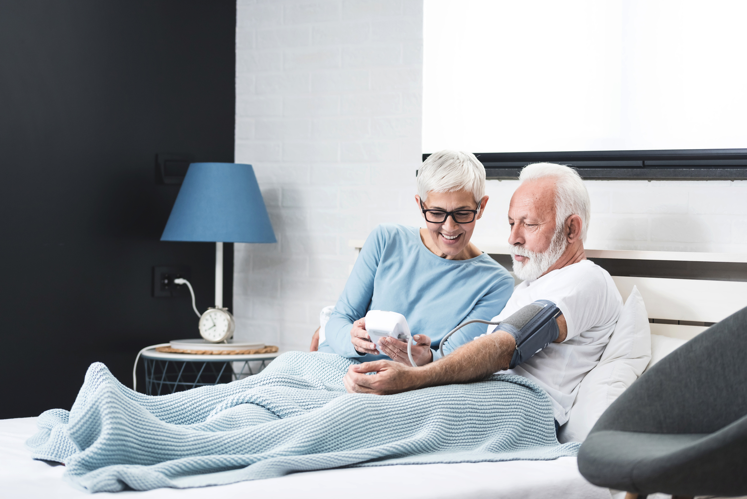 Ederly couple measures blood pressure